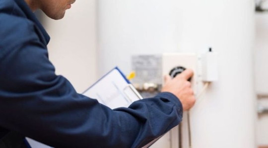 Technician checking a water heater