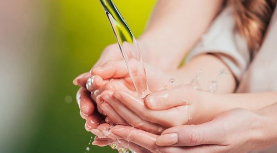 Woman and little kid washing their hands